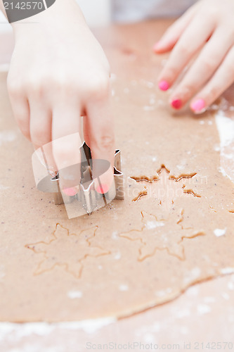 Image of Cutting gingerbread shapes from dough