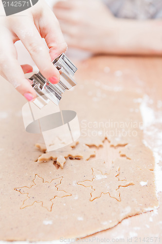 Image of Cutting gingerbread shapes from dough