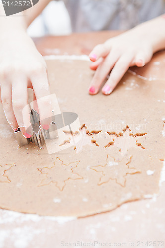 Image of Cutting gingerbread shapes from dough