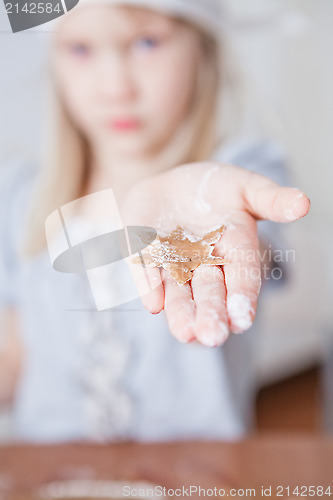 Image of Young girl showing gingerbread shape