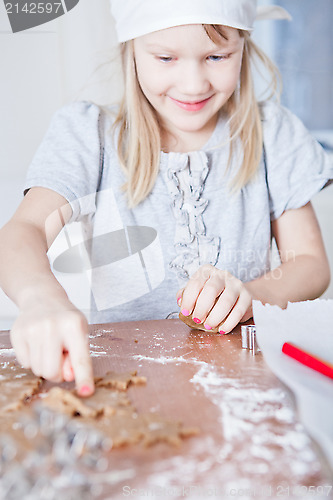 Image of Young girl pointing to gingerbread shape