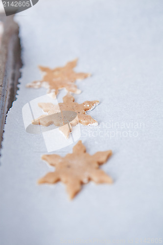 Image of Three shaped gingerbread dough pieces