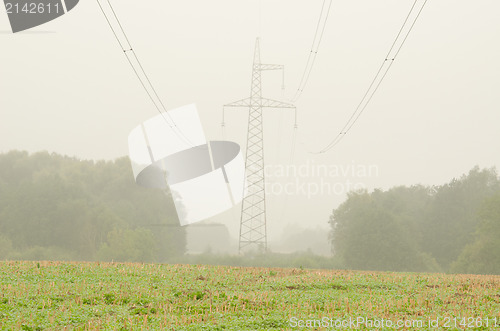 Image of agriculture field high voltage electricity pole wire fog 