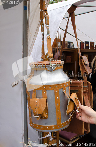 Image of churn brown leather straps pockets long handle 