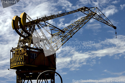 Image of street lamp clouds and crane in argentina