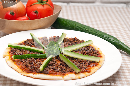 Image of Turkish beef pizza with cucumber on top