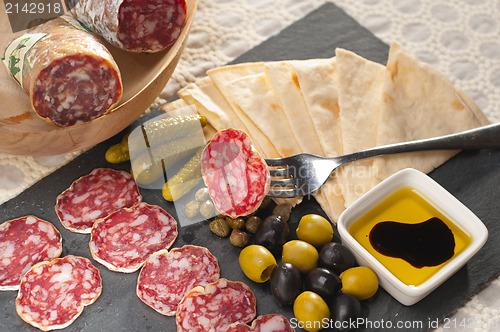 Image of cold cut platter with pita bread and pickles