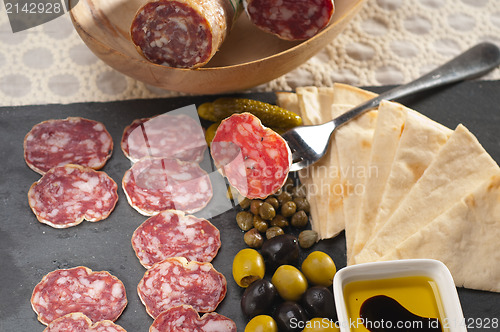 Image of cold cut platter with pita bread and pickles