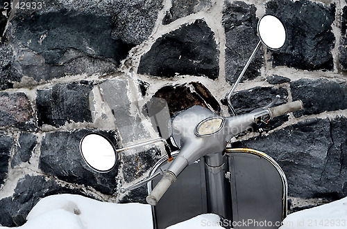 Image of scooter covered with snow 