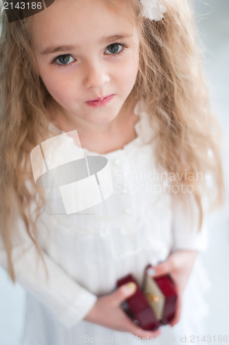 Image of Beautiful girl with small box in hands