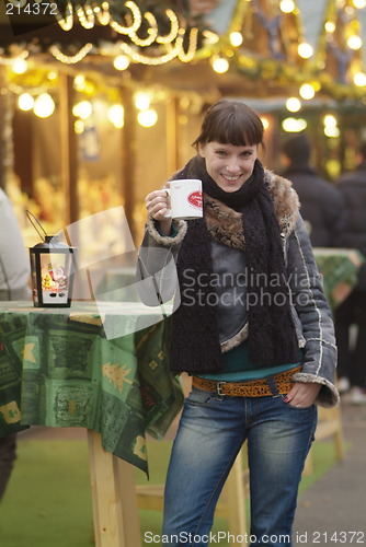 Image of young woman drinks glogg