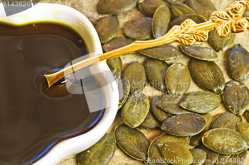 Image of pumpkin seed oil with seeds