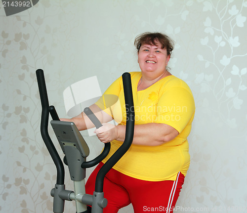 Image of overweight woman exercising on trainer