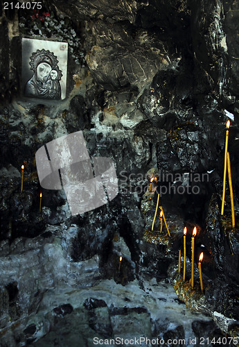 Image of icon and candles in grotto