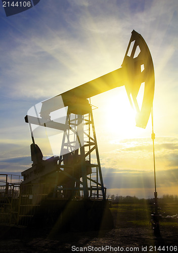 Image of working oil pump at sunset