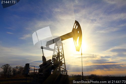 Image of working oil pump at sunset