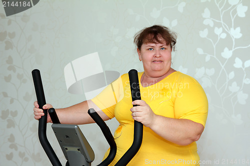 Image of overweight woman exercising on trainer