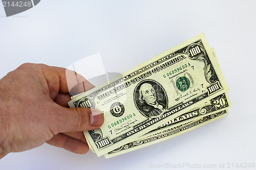 Image of Hand holding US dollars on a white background