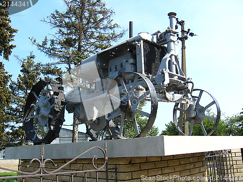 Image of Ancient tractor on a pedestal