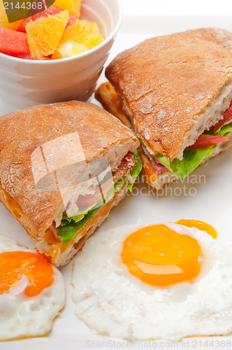 Image of ciabatta panini sandwich eggs tomato lettuce