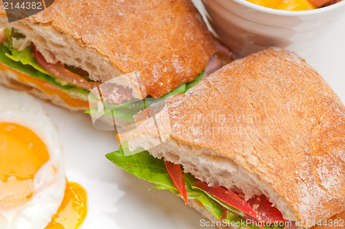 Image of ciabatta panini sandwich eggs tomato lettuce