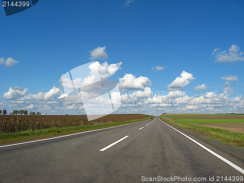 Image of asphalted road and the blue sky