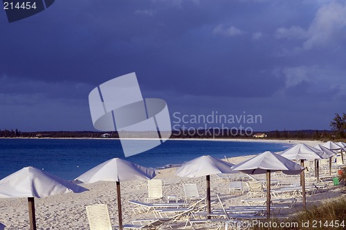 Image of ocean beach with chairs umbrellas
