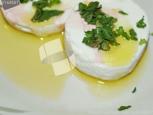 Image of Tomino cheese with rucola and olive oil