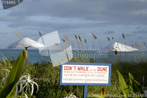Image of sign on the beach by dunes