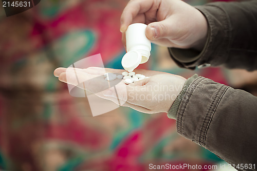 Image of Man with Drugs in the hands on a wall background