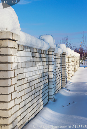 Image of Brick wall, covered with snow in January