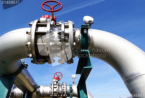 Image of Industrial zone, Steel pipelines and valves against blue sky