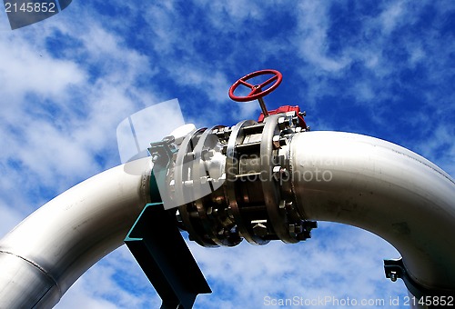 Image of Industrial zone, Steel pipelines and valves against blue sky