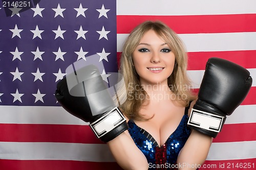 Image of Smiling young blonde with boxing gloves