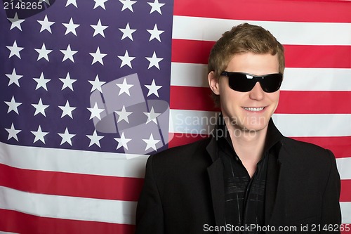 Image of Smiling young man in sunglasses