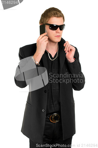 Image of Young man in sunglasses with a phone