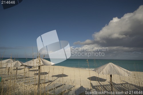 Image of ocean beach with chairs umbrellas