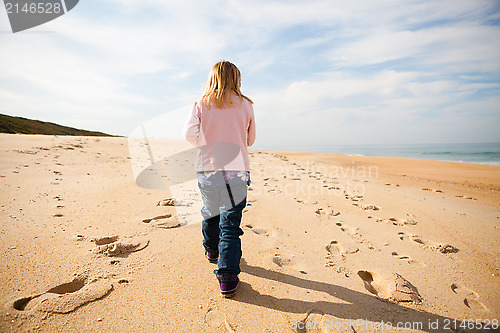 Image of Young girl walking on beach