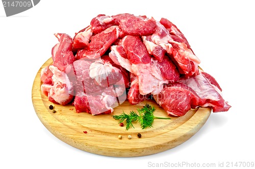 Image of Meat cut into slices on a round board