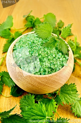 Image of Salt green in a wooden bowl with nettles on the board