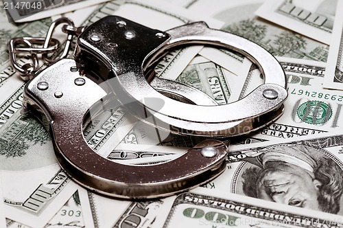 Image of Dollars and handcuffs