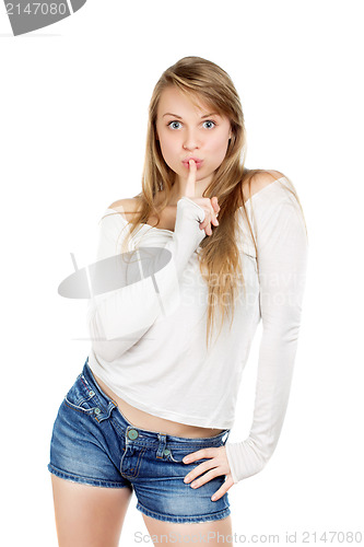 Image of Woman shows gesture to be quiet