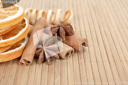 Image of Star Anise, cinnamon and dried orange wooden background 