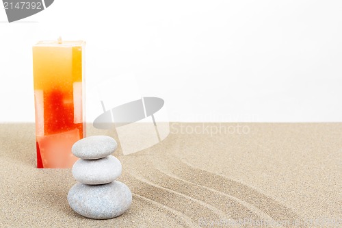 Image of Balance zen stones and candle in sand on white