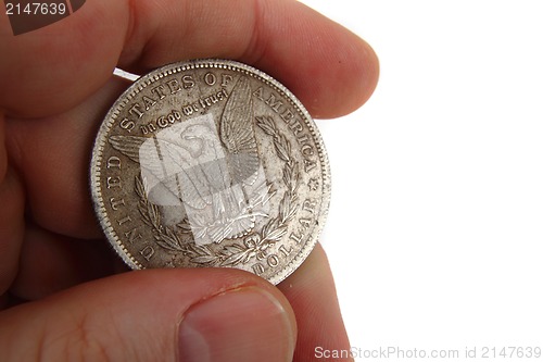 Image of dollar coins in human hand