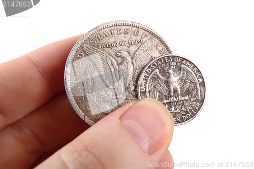 Image of dollar coins in human hand