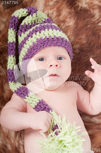 Image of Newborn baby in long striped hat