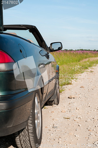 Image of Dark green cabrio on the road