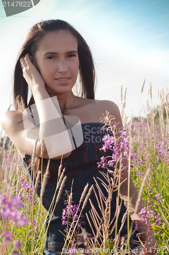 Image of Beautiful brunette woman in field