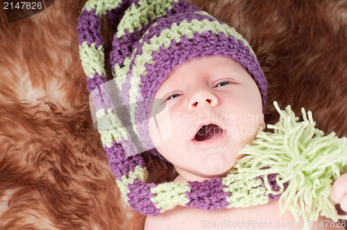 Image of Newborn baby in long knited hat